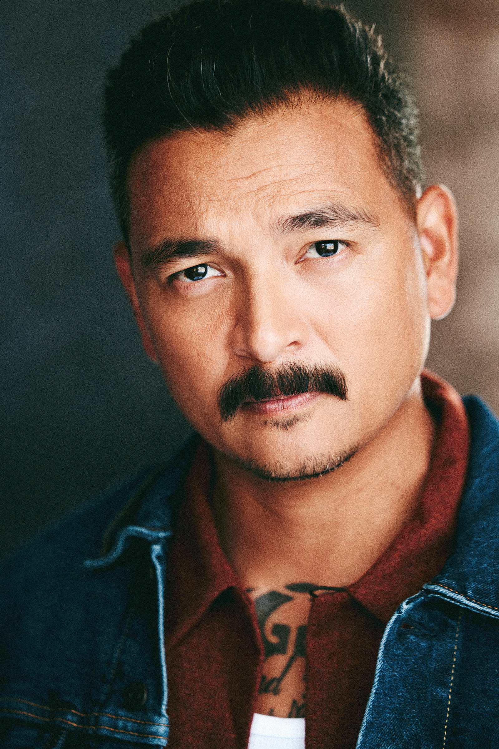 headshot with intense side look and mustache