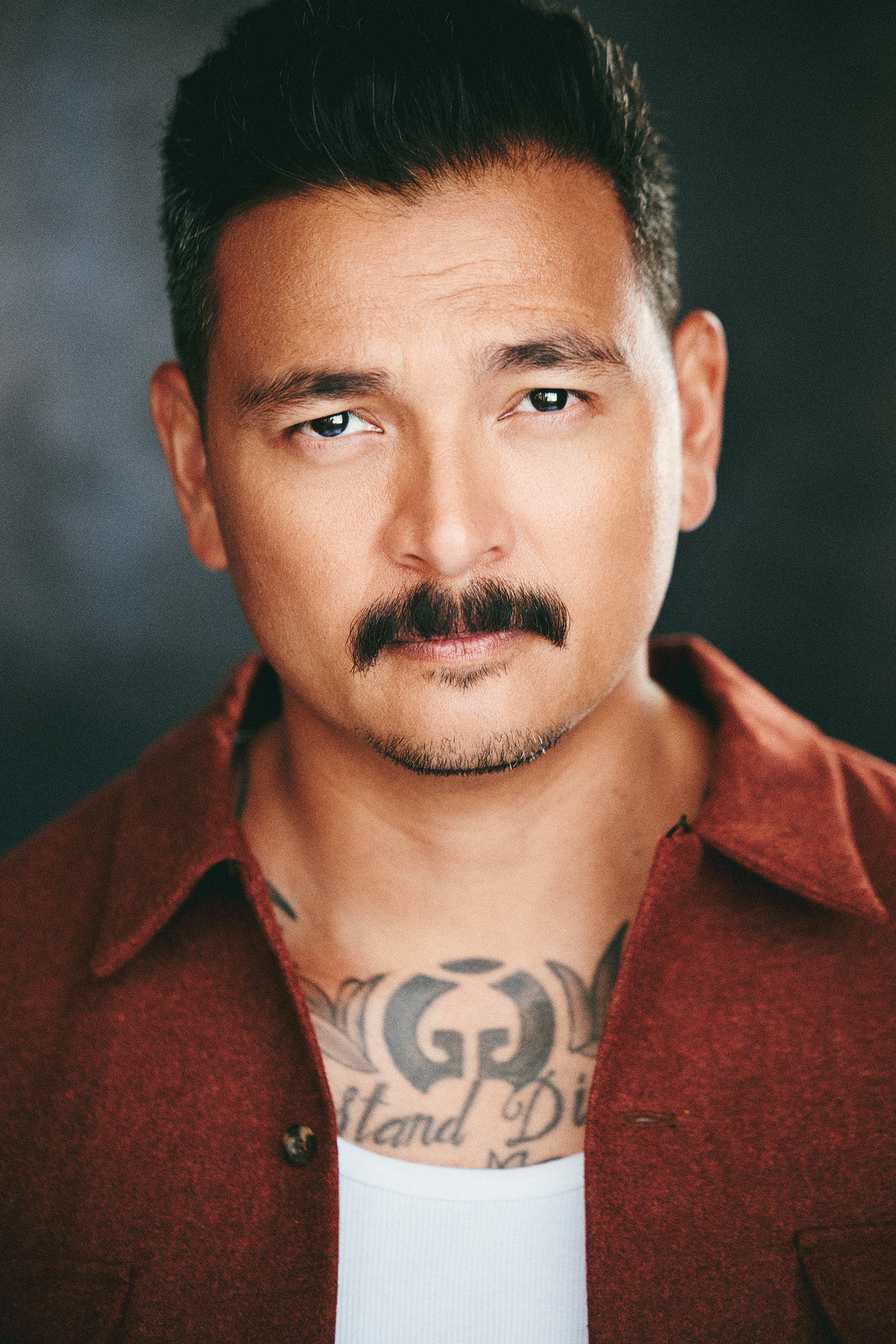 headshot with intense stare and mustache